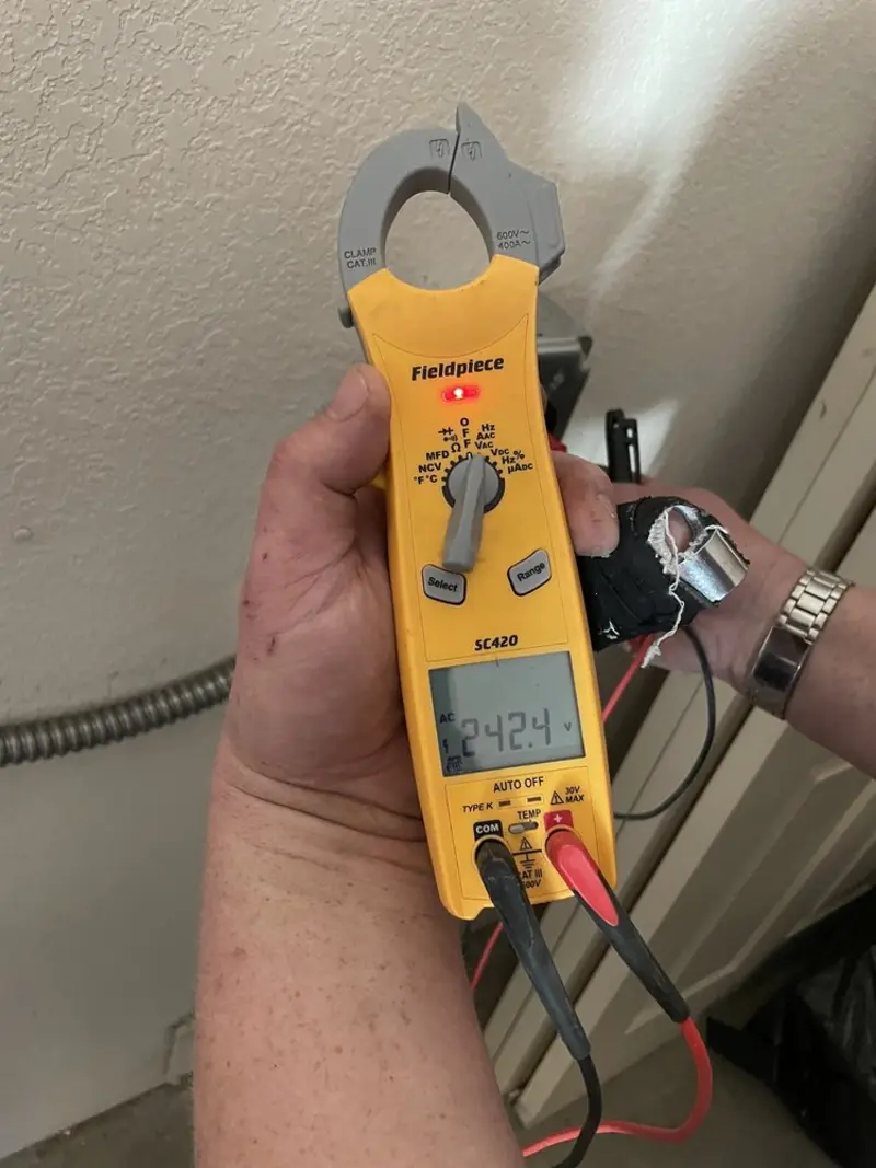 Voltage testing with clamp meter during Outlet Installation in Denville